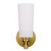 Aged gold outdoor wall sconce with an opal glass panel, illuminated.