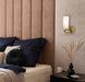 Cropped view of an aged gold outdoor wall sconce with an opal glass panel.