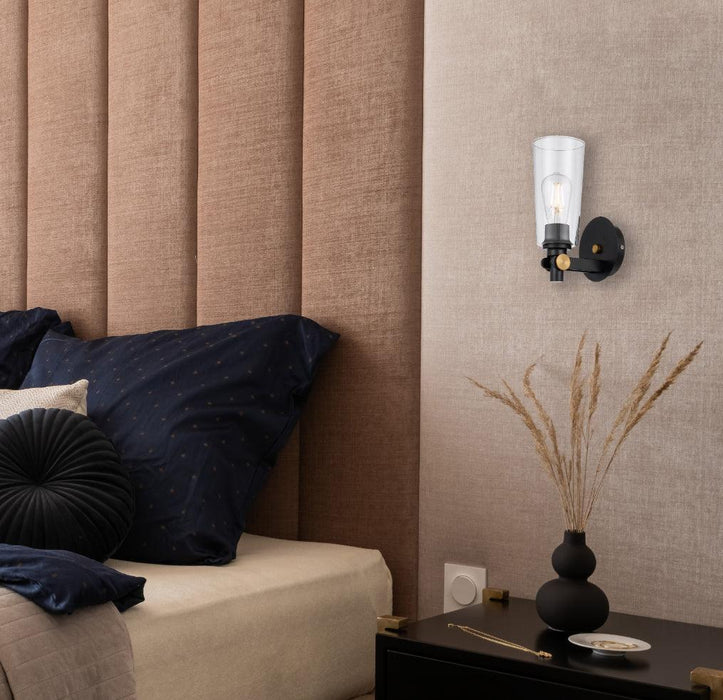 Cropped view of a black outdoor wall sconce with a clear glass panel.