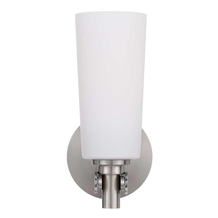 Nickel outdoor wall sconce with an opal glass panel, illuminated.
