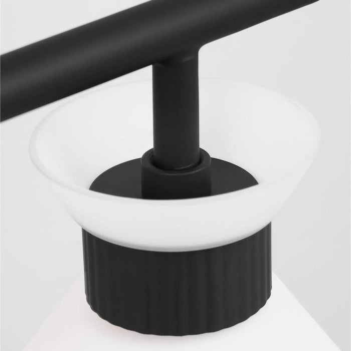 A close-up of a matte black circular flush mount light showing the diffuser.