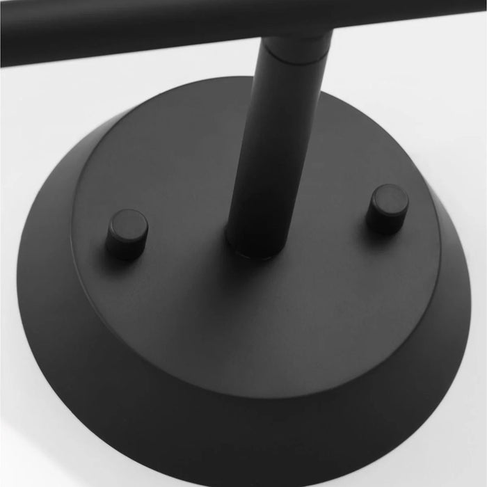 A matte black circular flush mount ceiling light with a white diffuser.