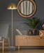 Black floor lamp with a dome-shaped shade and a black terrazzo base, cropped view.