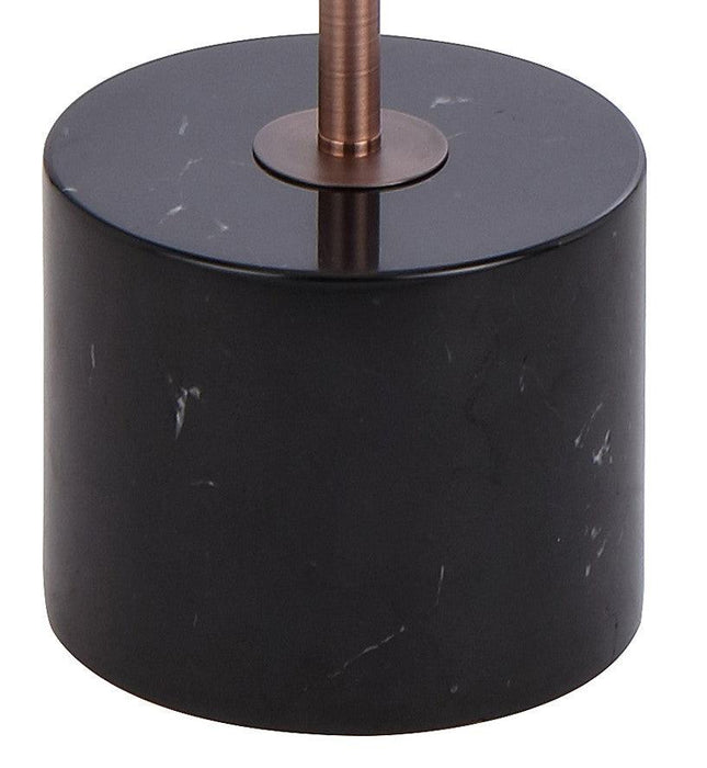 Close-up of the black and bronze base of a floor lamp.