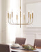 Distressed black and brass modern circular ceiling light with six spherical clear glass shades, in a room setting.