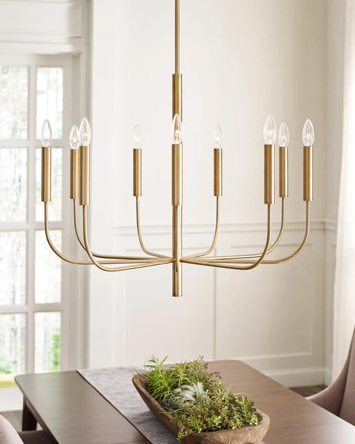 Distressed black and brass modern circular ceiling light with spherical clear glass shades, in a room setting.