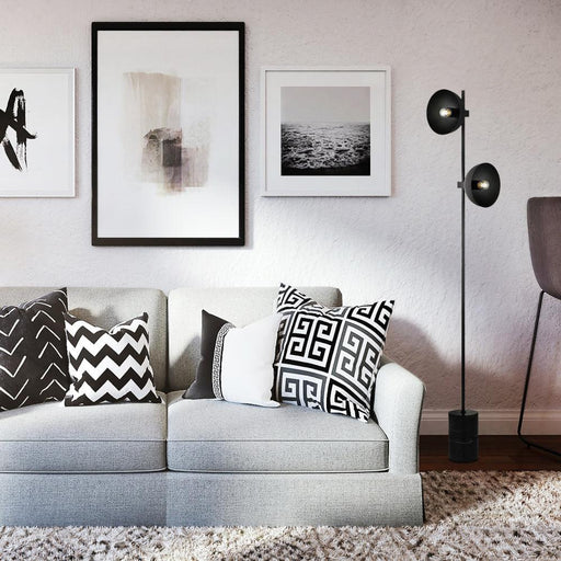 Black floor lamp with a spherical glass shade, cropped view.