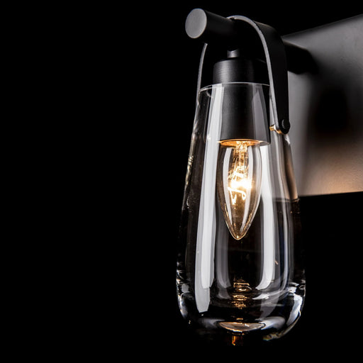 An angled view of a modern ceiling fan with dark blades and an integrated light.