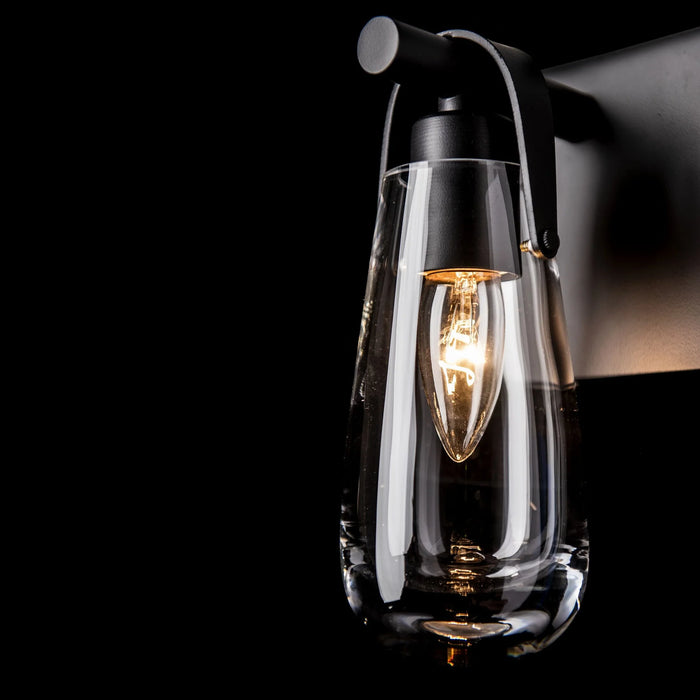 An angled view of a modern ceiling fan with dark blades and an integrated light.