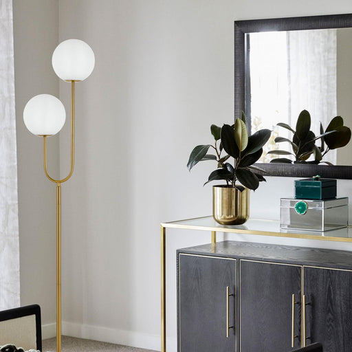 Gold floor lamp with a rectangular light panel, illuminated.