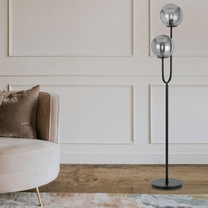 Black floor lamp with a rectangular light panel, illuminated.