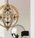 White five-light pendant with conical shades, illuminated.