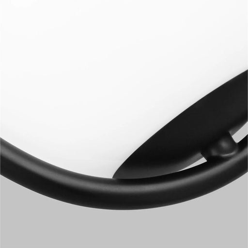 A close-up of a black flush mount ceiling light showing the detail of its diffuser.
