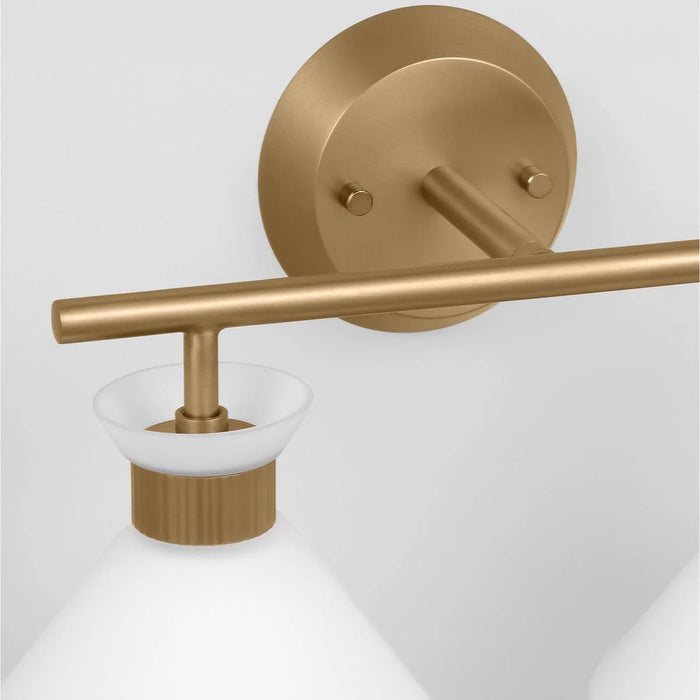A close-up of a satin brass circular flush mount light showing the diffuser.