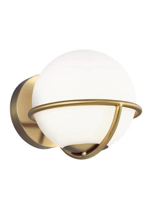 Distressed black and brass modern wall light with a cylindrical clear glass shade.