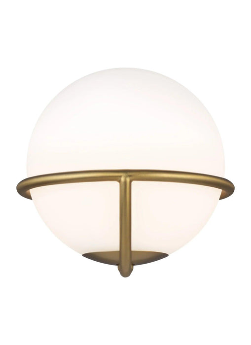 Distressed black and brass modern wall light with a cylindrical clear glass shade, angled view.