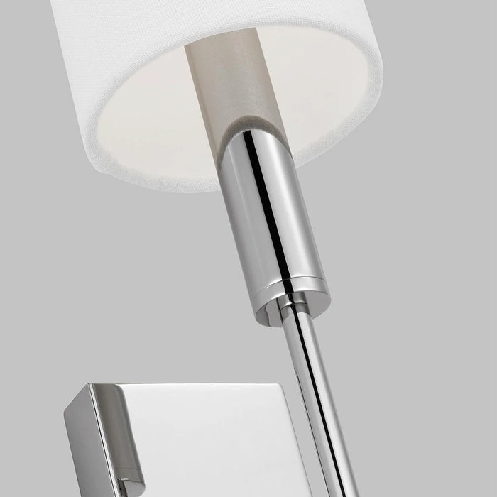 A close-up of a modern polished nickel ceiling fan showing the light kit.