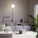 Large, modern wall sconce with a rectangular, metallic frame, angled view.