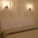 Large, modern wall sconce with a rectangular, metallic frame, angled view.