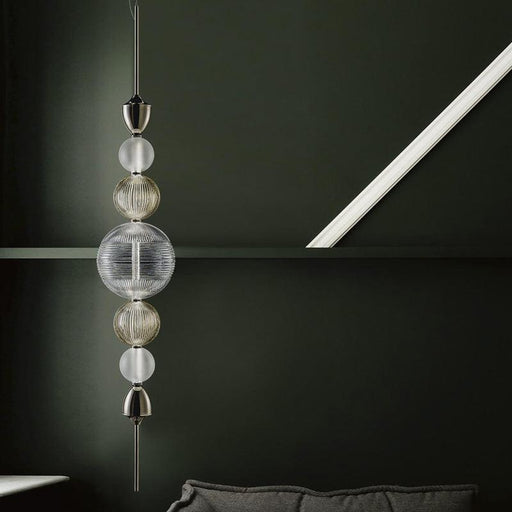 Large, modern wall sconce with a rectangular, metallic frame, angled view.