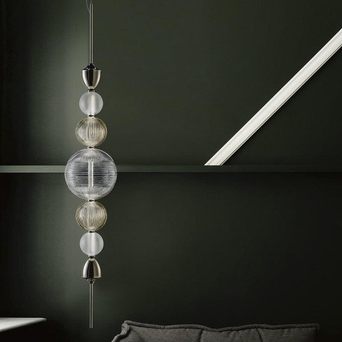 Large, modern wall sconce with a rectangular, metallic frame, angled view.