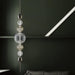 Large, modern wall sconce with a rectangular, metallic frame, angled view.