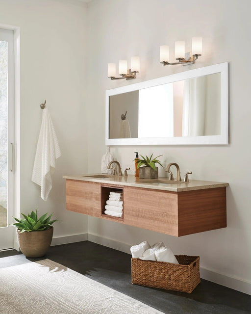 Modern multi-light chandelier with frosted cylindrical shades, in a bathroom setting.