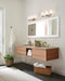 Modern multi-light chandelier with frosted cylindrical shades, in a bathroom setting.
