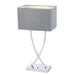 Chrome table lamp with a cylindrical base and a spherical glass shade.