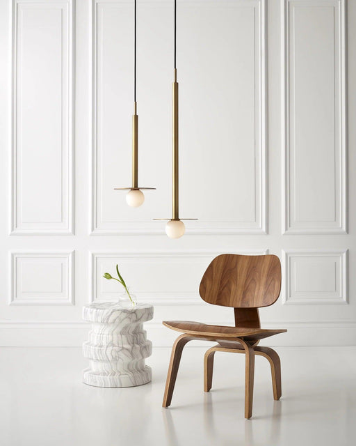 Distressed black and brass modern pendant light with a shallow bowl shade, in a room setting.