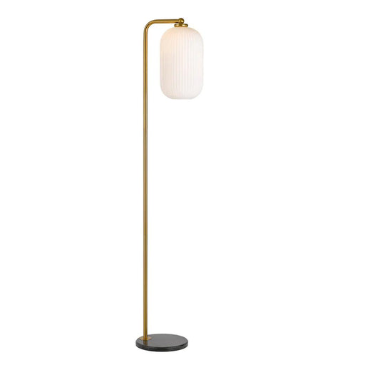 Aged gold floor lamp with a cylindrical base and an opal glass shade.