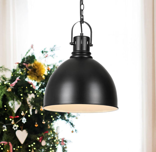 Black pendant light with a clear glass diffuser, illuminated.