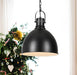 Black pendant light with a clear glass diffuser, illuminated.