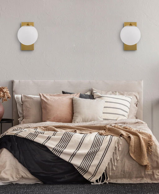 Cropped view of an aged gold outdoor wall sconce with upward/downward light.