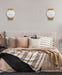 Cropped view of an aged gold outdoor wall sconce with upward/downward light.