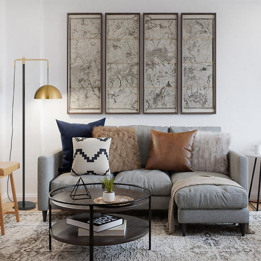 Black and aged gold floor lamp with a spherical glass shade, cropped view.