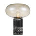 Black and amber table lamp with a cylindrical base and a spherical glass shade.