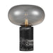 Black and smoky table lamp with a cylindrical base and a spherical glass shade.