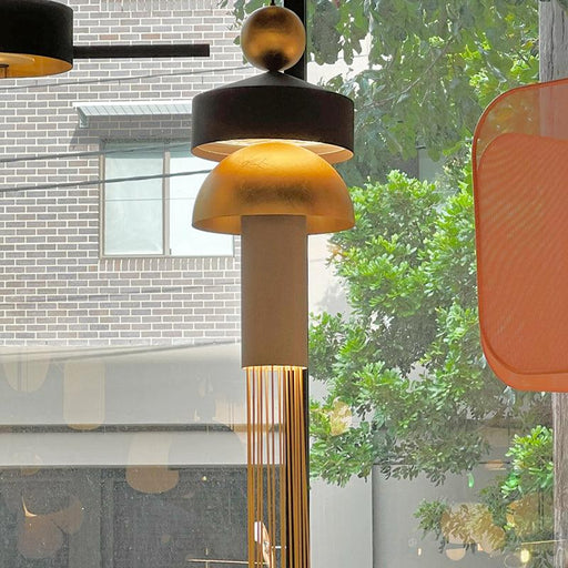 Large, elongated glass pendant light with a clear, textured surface.