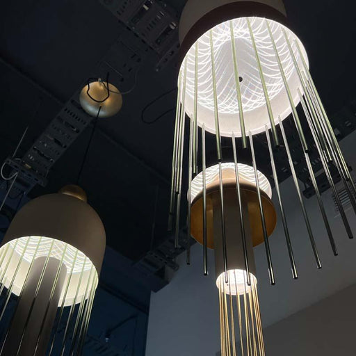 Cluster of large, elongated glass pendant lights with textured surfaces.