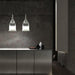 Large, modern wall sconce with a rectangular, metallic frame, angled view.