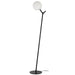 Black floor lamp with a cylindrical base and an opal glass shade.