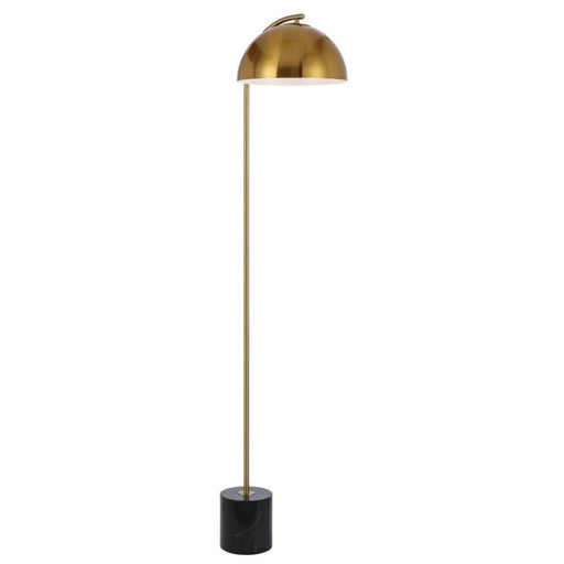 Black and aged gold floor lamp with a cylindrical base and a spherical glass shade.