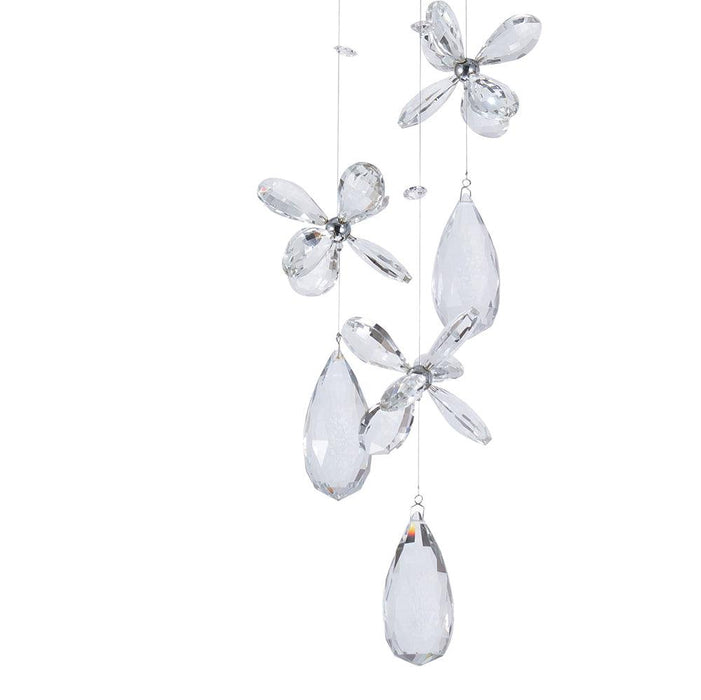 Chrome pendant light with four spherical glass shades, angled view.