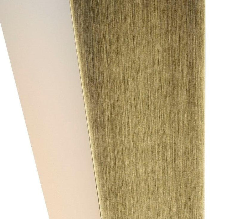 Aged bronze outdoor wall sconce with a rectangular shape and a clear glass panel, illuminated.
