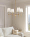 Bronze four-light chandelier with clear seeded glass shades, in a dining room setting.