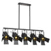 Black five-light linear pendant light with cylindrical clear glass shades and exposed bulbs.