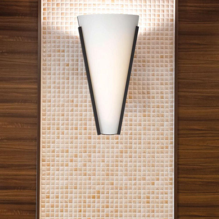 Black outdoor wall sconce with a rectangular shape and a clear glass panel, illuminated.