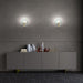 Large, modern wall sconce with a rectangular, metallic frame, angled view.