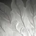 Large, decorative wall art with a textured, leaf-like pattern, side view.